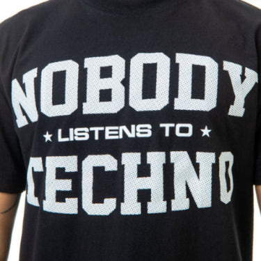 Black t-shirt with white text 'NOBODY LISTENS TO TECHNO' on a white background