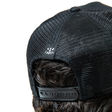 Black mesh cap with a brand label on a white background