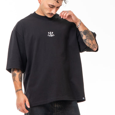 Person wearing a black t-shirt and jeans on a white background