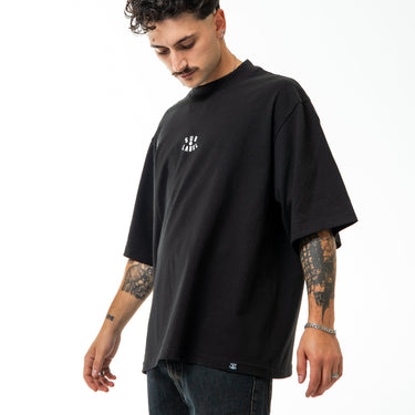 Man wearing a black t-shirt with a white logo on a white background