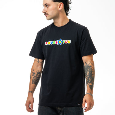 Man wearing a black t-shirt with colorful text on a white background