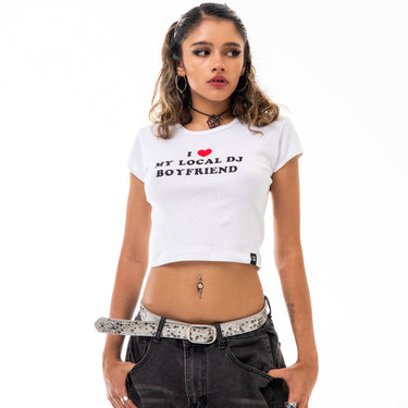 Woman wearing a white t-shirt with text and black pants on a white background