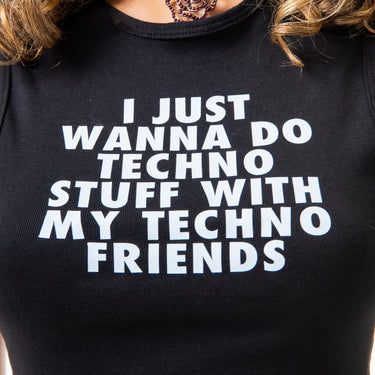 Black t-shirt with white text 'I JUST WANNA DO TECHNO STUFF WITH MY TECHNO FRIENDS' worn by a person.