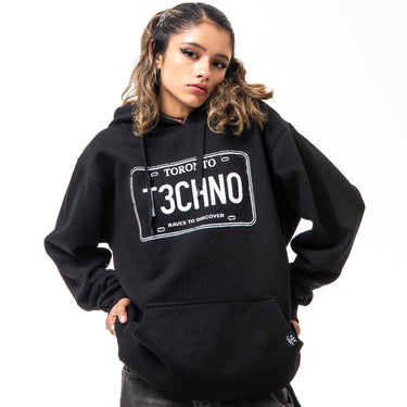 Person wearing a black hoodie with 'Toronto Techno' design on a white background