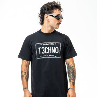 Man wearing a black t-shirt with 'Toronto T3CHNO' design on a white background