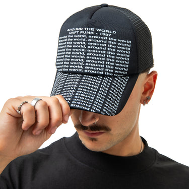 Person wearing a black cap with white text on a white background