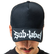 Person wearing a black cap with 'Sub Label' logo on a white background