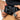 Person holding a black belt with a visible brand logo against a neutral background