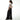 Person wearing a white crop top and black wide-leg pants on a white background