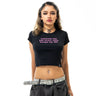 Person wearing a black t-shirt with pink text on a white background