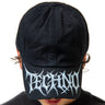 Black cap with white 'techno' logo worn by a person on a white background