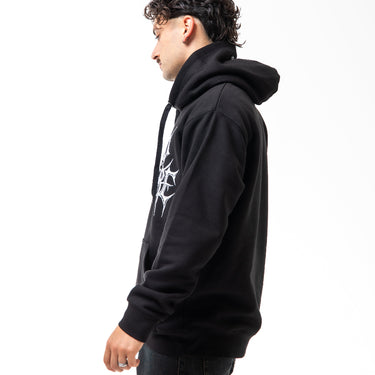 Person wearing a black hoodie with a white logo on a white background