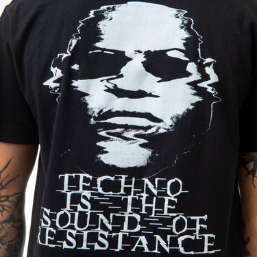 Black t-shirt with white graphic and text on a person wearing it.
