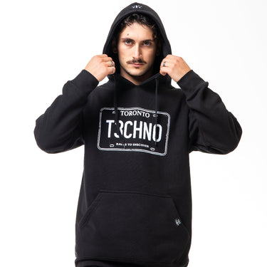 Person wearing a black hoodie with 'Toronto Techno' license plate design on a white background